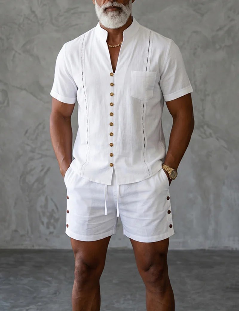 Best Men's Mandarin Collar Short Sleeve Shirt and Shorts Set for Resort and Summer Vacation Outfits A stylish man standing outdoors wearing a white Ekouaer men's casual mandarin-collar short-sleeve shirt and matching shorts set with gold buttons, showcasing sophisticated resort fashion and summer vacation style for the UK and USA.