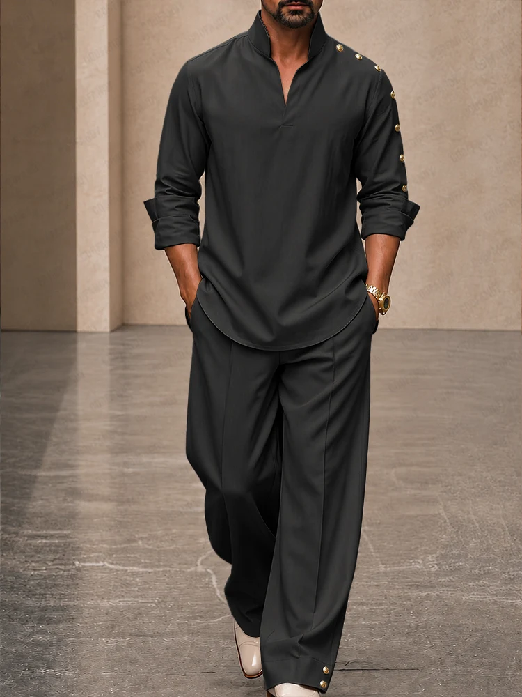 A fashion model wearing a black Casual Loose Button Accents Sleeve Shirt Pants Set from Coofandy, featuring button-accented lantern sleeves and an elastic drawstring waist, highlighting a sophisticated men's Streetwear Style outfit for urban daily wear.